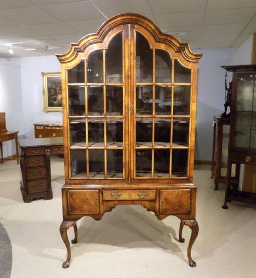A Walnut Queen Anne Style Domed Cabinet on Stand.