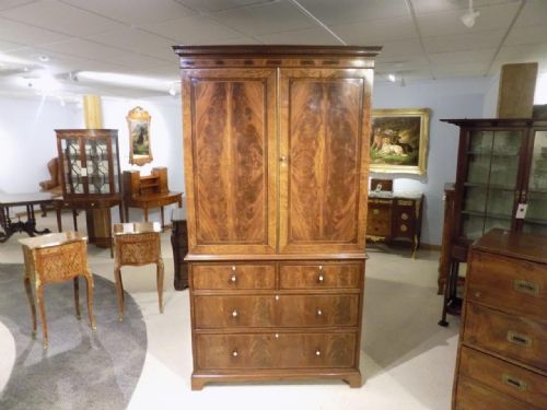 A Fine Quality Fiddle Back & Flame Mahogany Linen Press by Maple & Co of London.