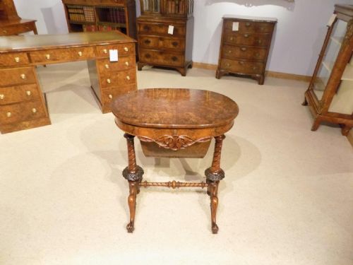 A Superb Quality Burr Walnut Victorian Period Oval Shaped Antique Sewing Table.