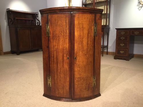 An Oak and Mahogany Cross Banded George III Period Corner Cupboard