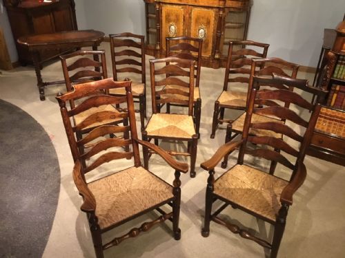 A Harlequin Set of 8 Early 19th Century Ash and Elm Ladder Back Kitchen Dining Chairs