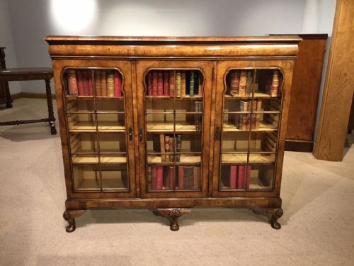 A Walnut Queen Anne Revival Three Door Bookcase.