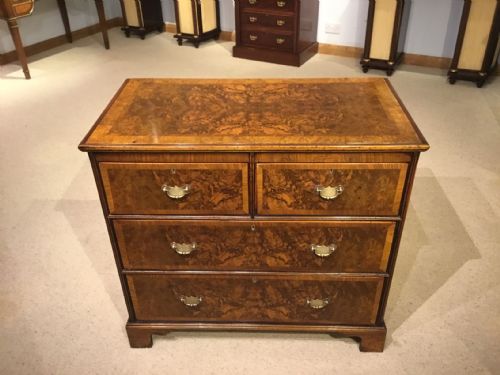 A Burr Walnut Georgian Style Antique Chest of Drawers by Heals of London.