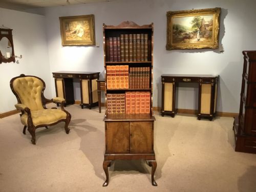 A 1920s Walnut Queen Anne Revival Waterfall Bookcase on Cupboard