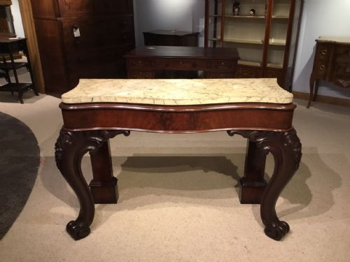 A Victorian Period Mahogany Serpentine Console Table.