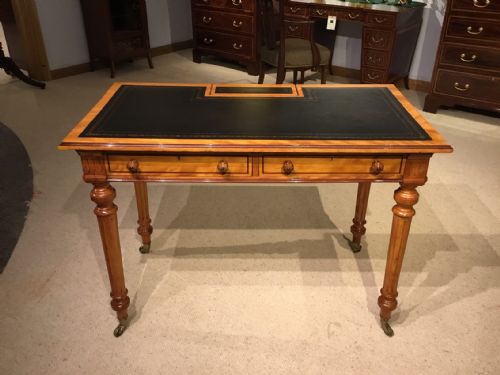A Satinwood and Purple Heart Victorian Period Writing Table by Gillows of Lancaster.