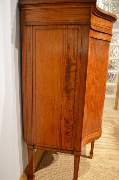 fig 1. A satinwood Edwardian Period serpentine antique display cabinet by Maple & Co
