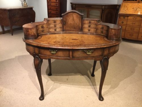 A Walnut George I Style Oval Antique Desk