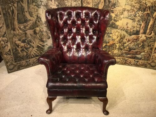 A Red Leather Georgian Style Wing Armchair