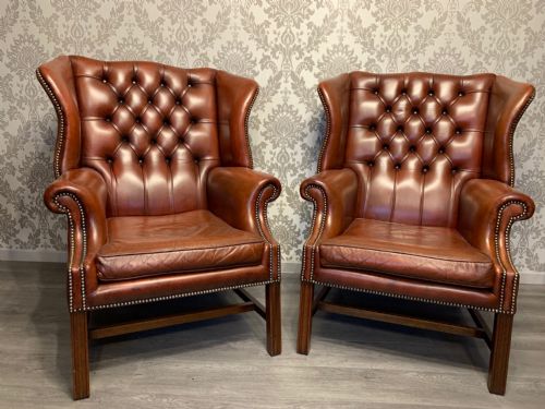 A Handsome Pair of Georgian Style Leather Wing Armchairs