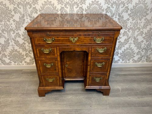 A George II Period Walnut and Herringbone Banded Knee Hole Desk