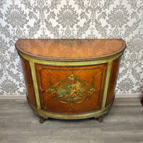 An Edwardian Period Sheraton Revival Satinwood Painted Demi Lune Cabinet.