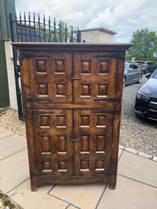 A Rustic Spanish Style Oak Panelled Cupboard