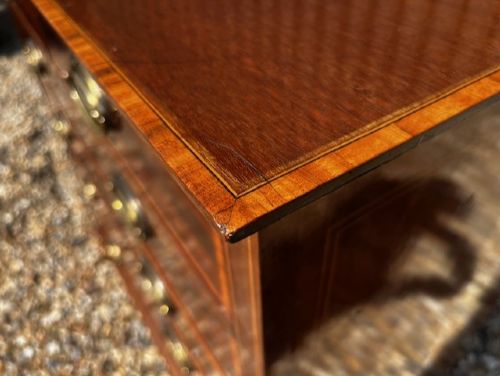 An Edwardian mahogany tall chest featuring two short drawers above four long drawers with satinwood crossbanding and brass oval drop handles. View V
