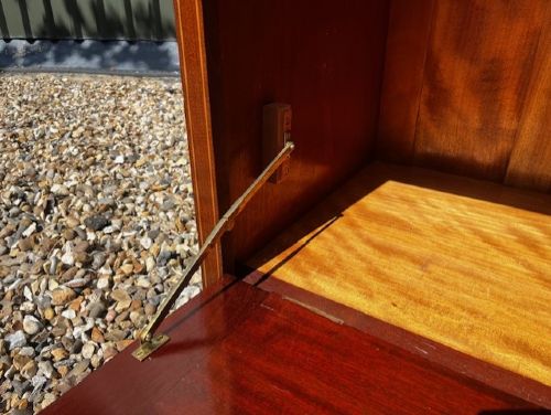 An Edwardian mahogany tall chest featuring two short drawers above four long drawers with satinwood crossbanding and brass oval drop handles. View X