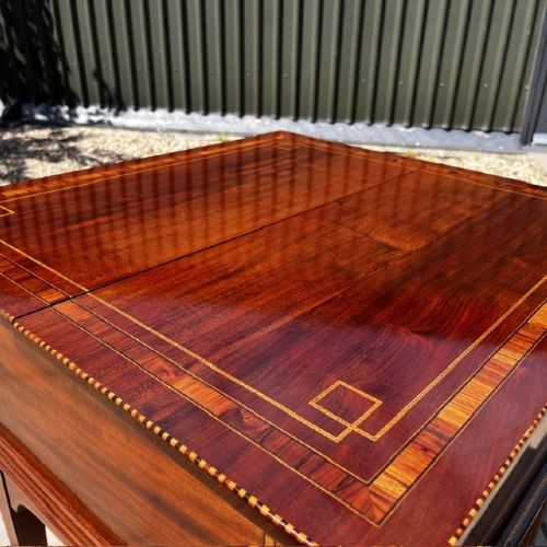 An Edwardian mahogany surprise drinks cabinet featuring satinwood inlay, square tapered legs, a lower shelf, and brass castors. View VIII