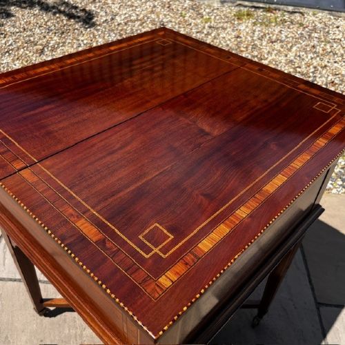 An Edwardian mahogany surprise drinks cabinet featuring satinwood inlay, square tapered legs, a lower shelf, and brass castors. View IX