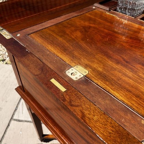 An Edwardian mahogany surprise drinks cabinet featuring satinwood inlay, square tapered legs, a lower shelf, and brass castors. View XII