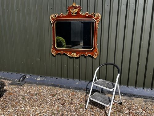 A Chippendale style horizontal wall mirror featuring a polished mahogany frame adorned with carved giltwood scrollwork and a central gilt eagle crest. View II