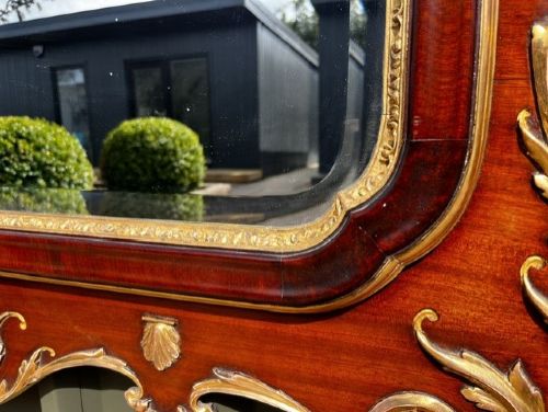 A Chippendale style horizontal wall mirror featuring a polished mahogany frame adorned with carved giltwood scrollwork and a central gilt eagle crest. View III