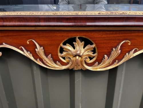 A Chippendale style horizontal wall mirror featuring a polished mahogany frame adorned with carved giltwood scrollwork and a central gilt eagle crest. View VI