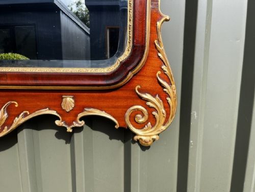 A Chippendale style horizontal wall mirror featuring a polished mahogany frame adorned with carved giltwood scrollwork and a central gilt eagle crest. View IX