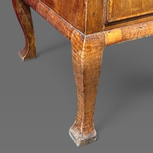 A George II period walnut chest on stand featuring multiple drawers with brass drop handles, supported by slender legs. View VI