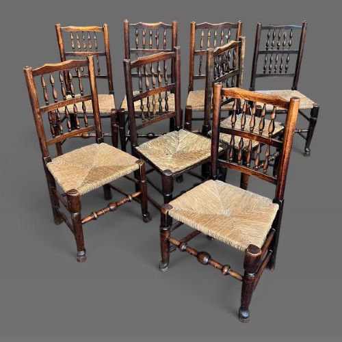 A set of ten dark oak Victorian Lancashire dining chairs with tiered spindle backrests and hand-woven rush seats. View III