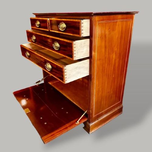 An Edwardian period Sheraton Revival mahogany tall chest featuring flame mahogany drawer fronts with inlay stringing and brass handles. View III