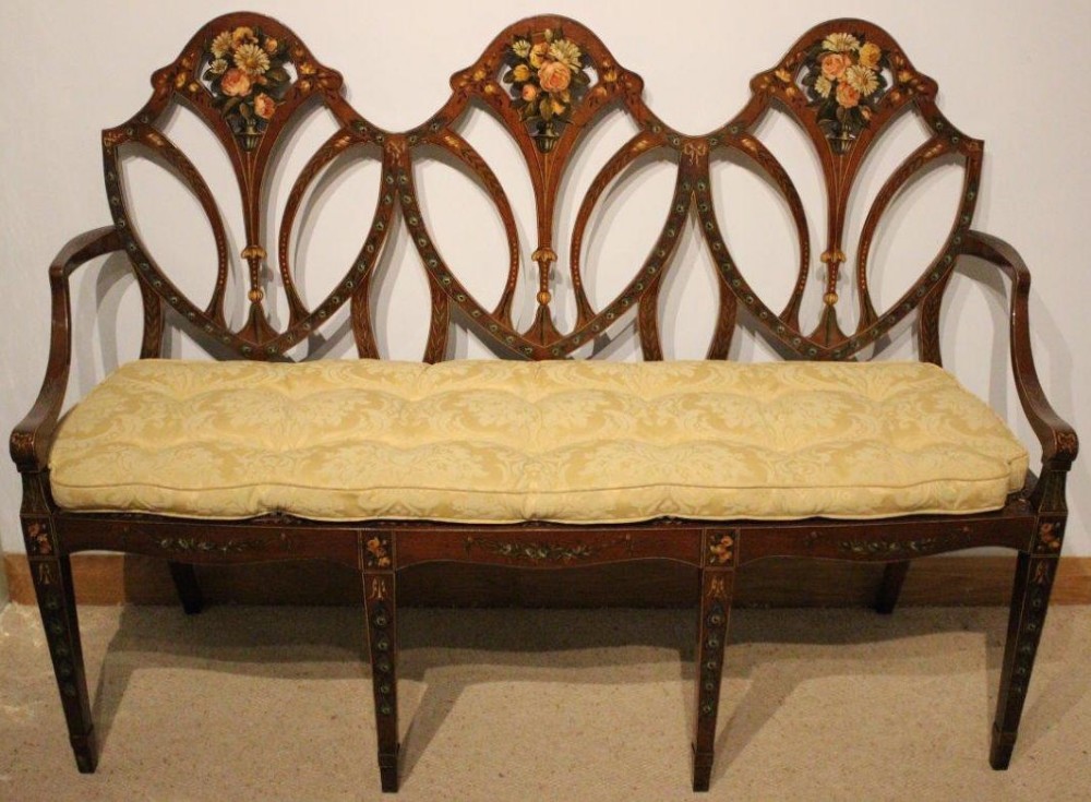A Sheraton Revival Edwardian Period triple shield back painted satinwood settee.