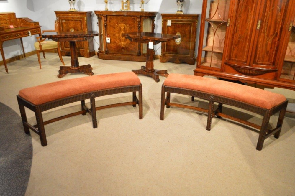 A fine pair of mahogany 19th Century Hepplewhite style concave shaped antique window seats