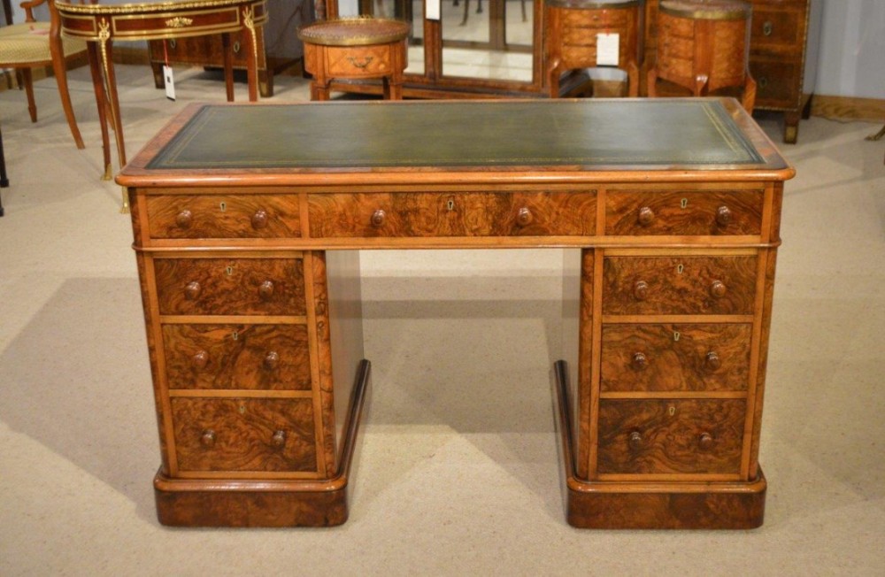 A burr walnut Victorian Period antique pedestal desk