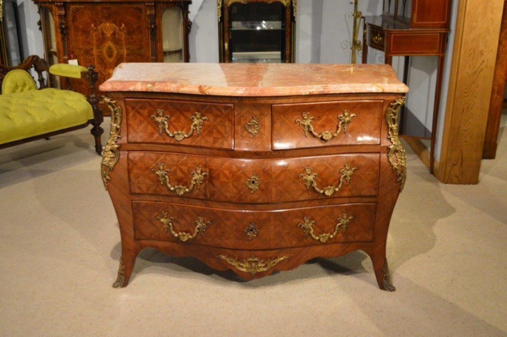 A Late19th Century French serpentine kingwood parqeutry commode/chest.