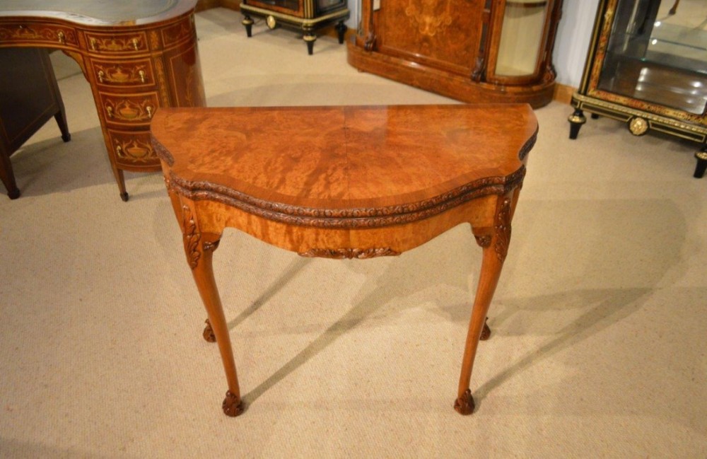 A burr walnut Georgian Style antique fold over card table.