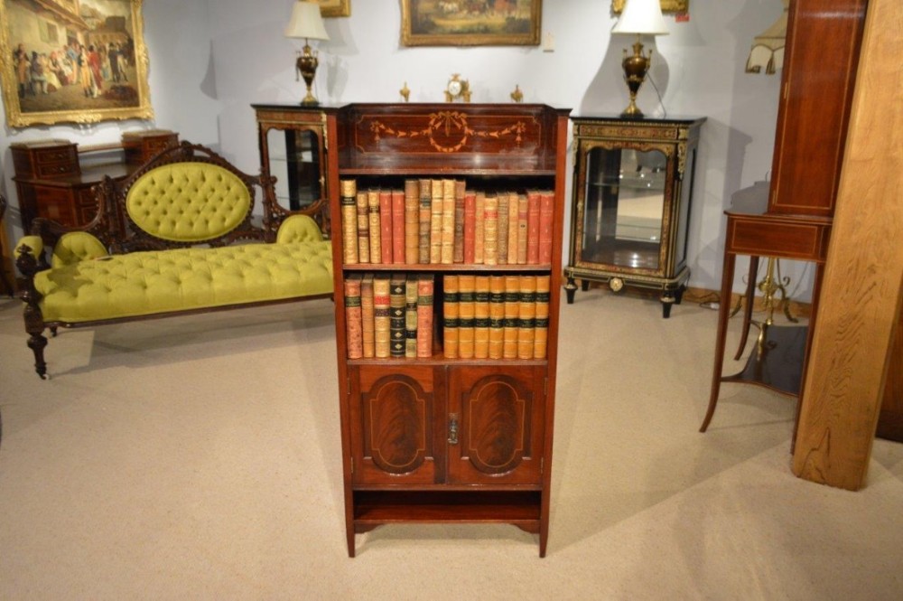 A small mahogany inlaid Edwardian Period mahogany bookcase by Shapland & Petter of Barnstaple.