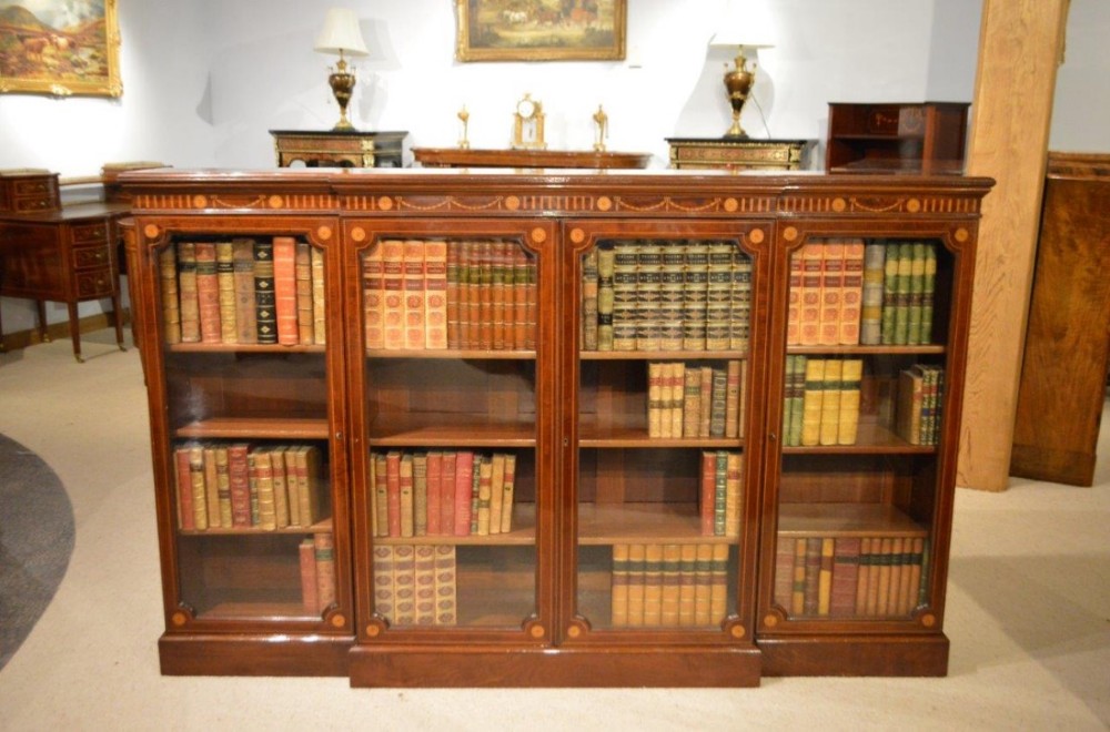 A beautiful  fiddleback mahogany Late Victorian Period Sheraton Revival breakfront bookcase. 