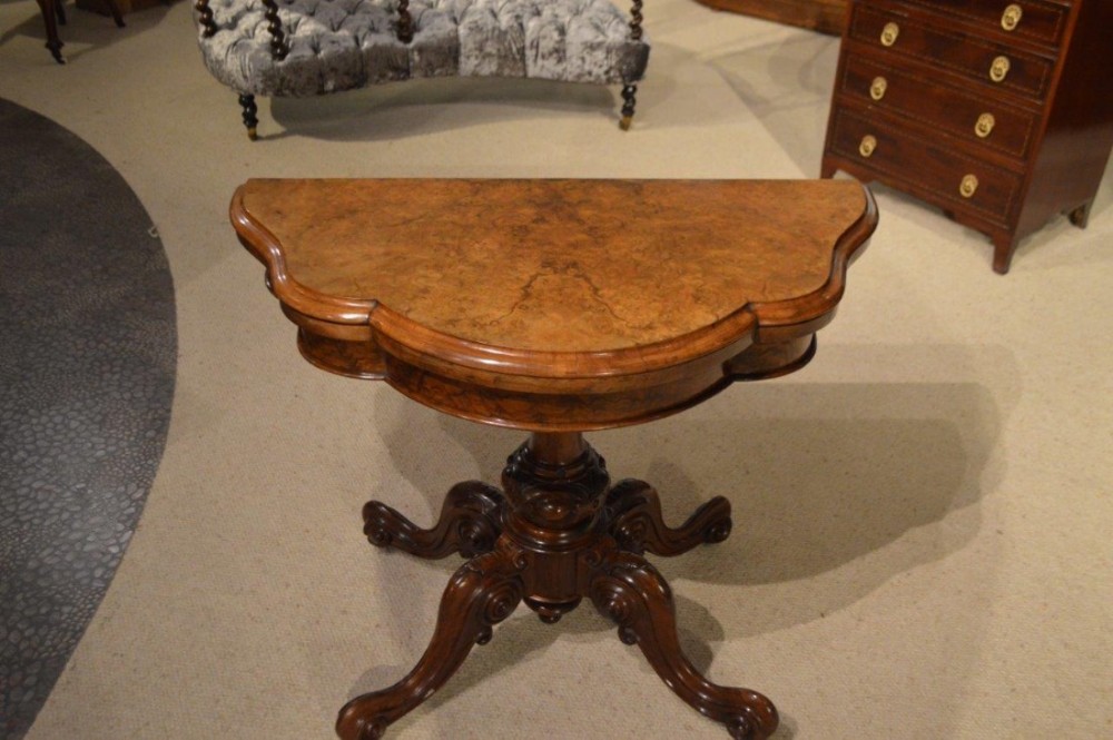 A burr walnut Victorian Period antique fold over card table.