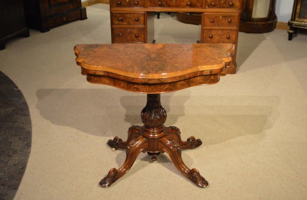 A burr walnut Victorian Period antique fold over card table.