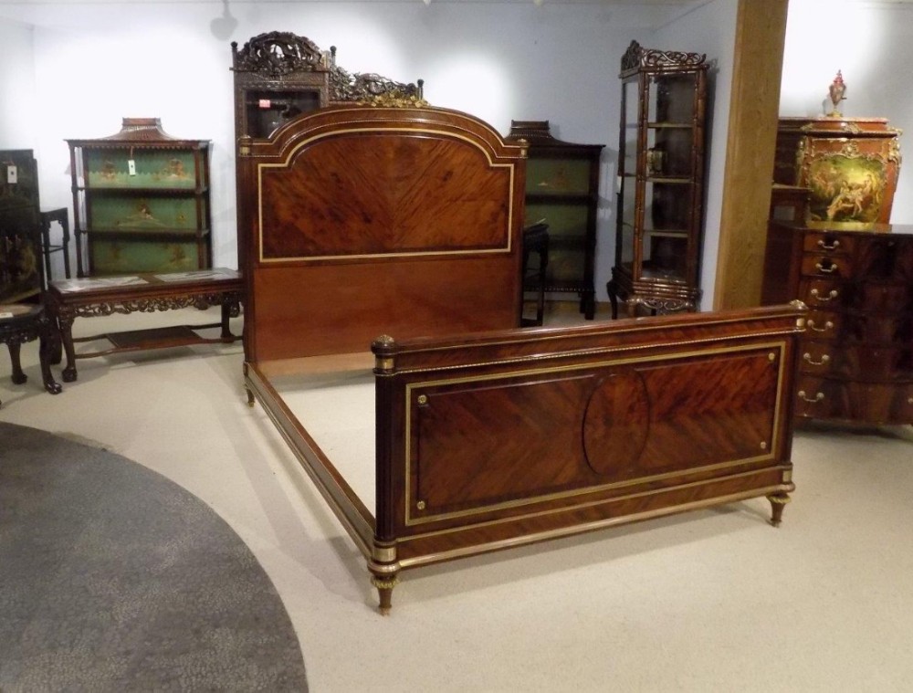 A superb French 19th Century figured mahogany and ormolu mounted antique kingsize bed