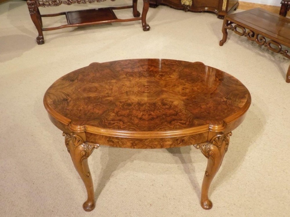 A burr walnut George I Revival oval antique coffee table