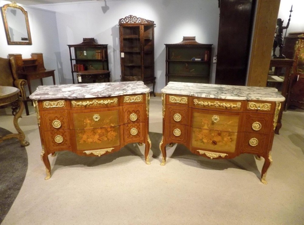 A magnificent pair of Louis XVI transitional style 19th Century French marble topped commodes after the original model by J.H. Riesener
