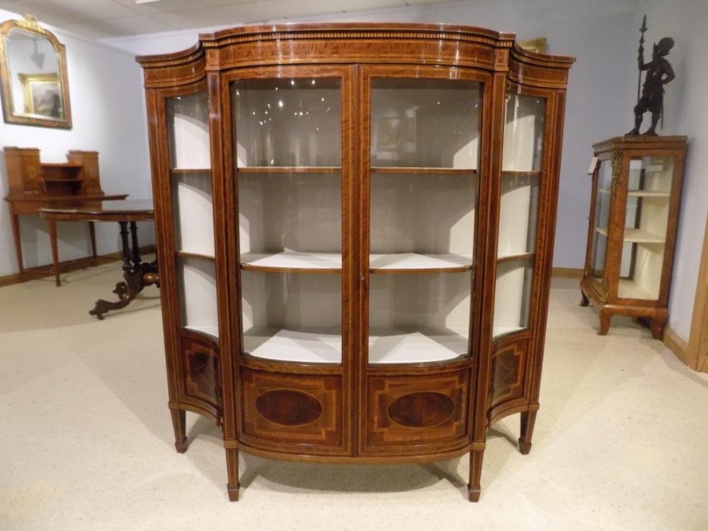A fine quality small mahogany inlaid Edwardian serpentine display cabinet