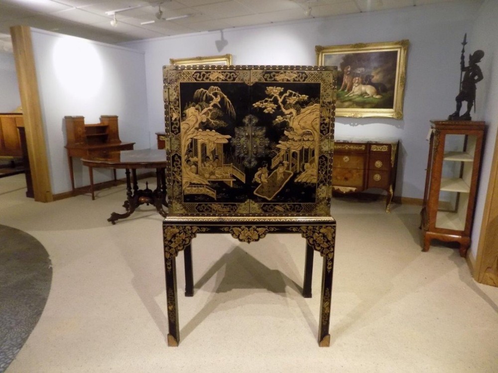 A Chinoiserie gold lacquered cocktail cabinet on stand