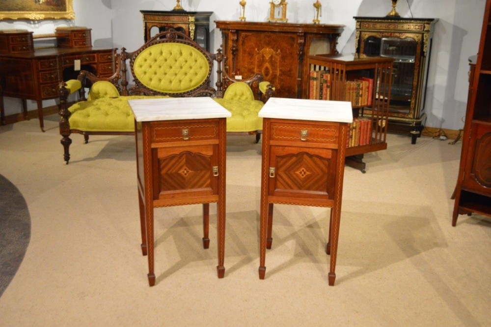 A good pair of mahogany inlaid French antique bedside cabinets