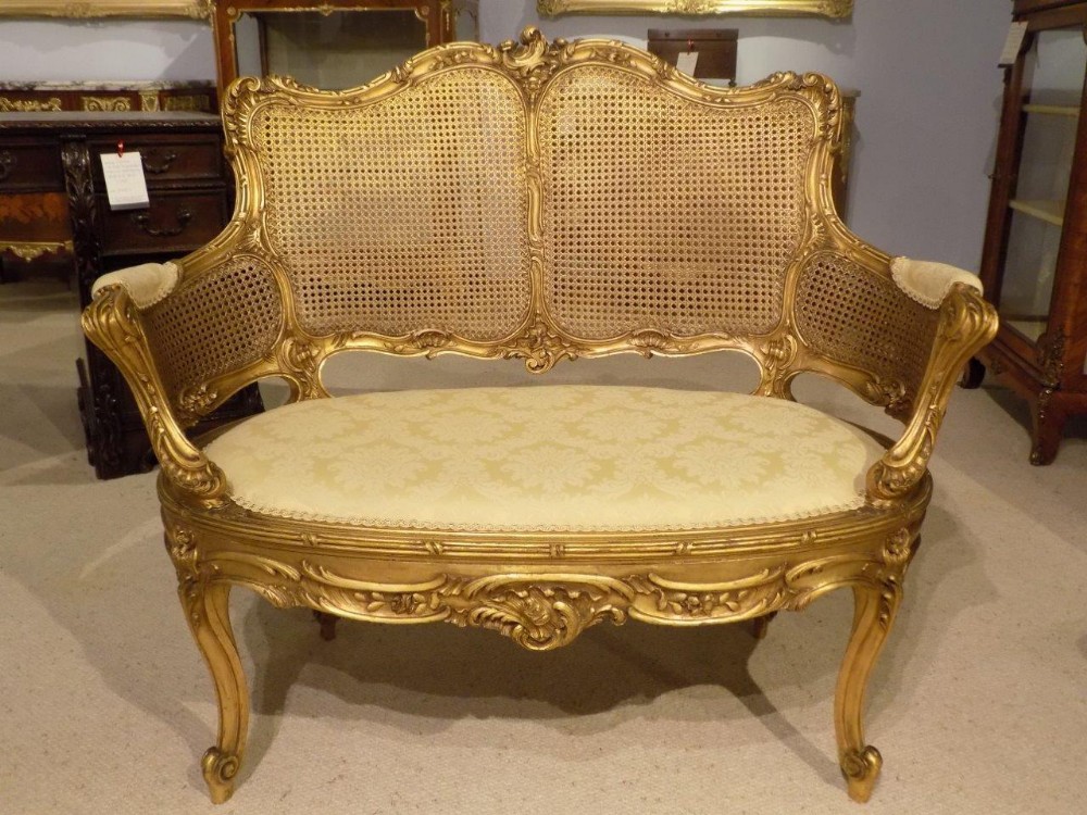 A Late 19th Century French carved gilt wood and bergere canapé