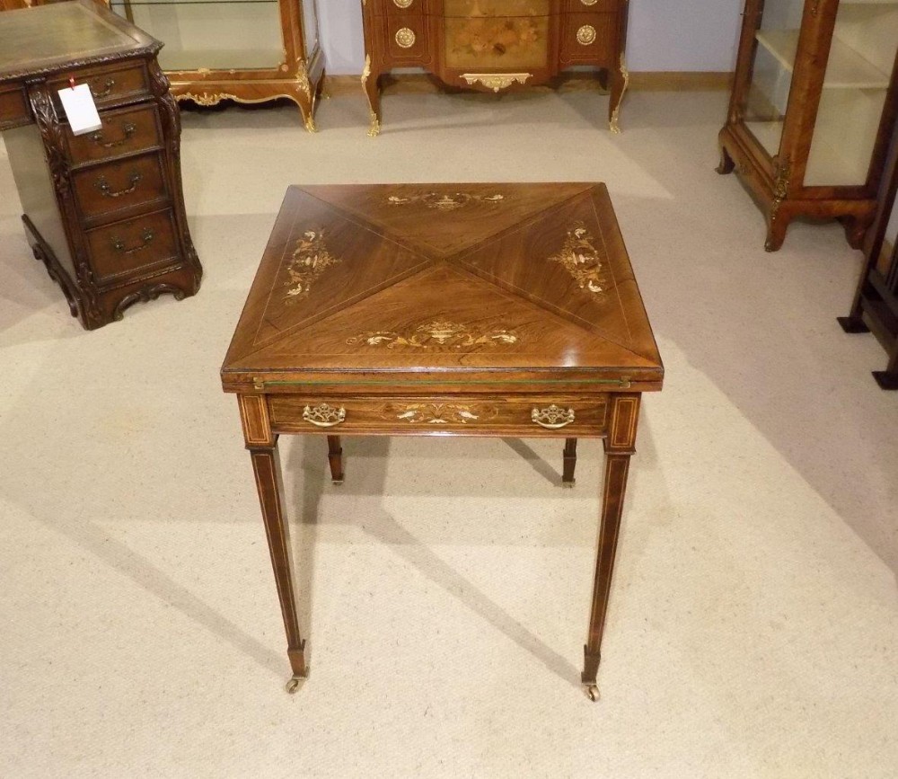 A beautiful rosewood and marquetry inlaid Late Victorian Period envelope card/games table