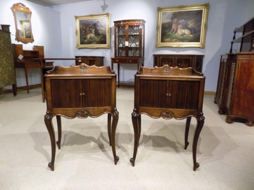 A pair of walnut Late 19th Century French tambour front antique bedside cabinets.