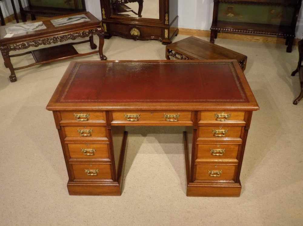 A mahogany Late Victorian Period antique pedestal desk by Hindley & Sons of London. 