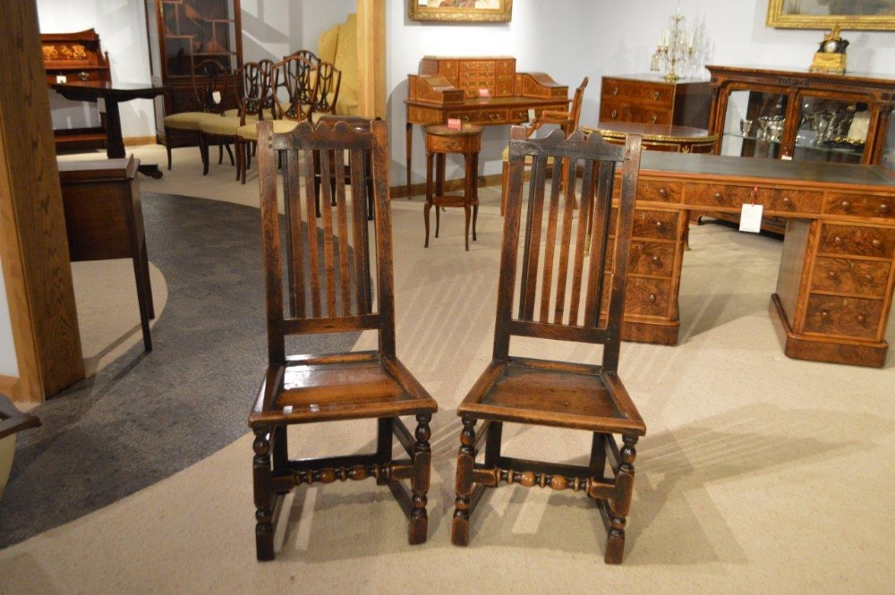 A pair of oak 17th Century antique hall chairs