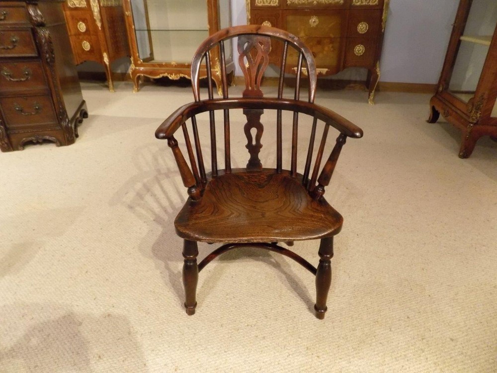 A rare yew wood 19th Century child's windsor armchair.